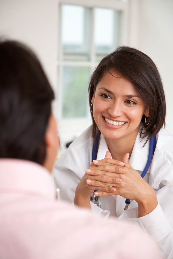 Doctor listening to a patient at her practice Doctor listening to a patient at her practice