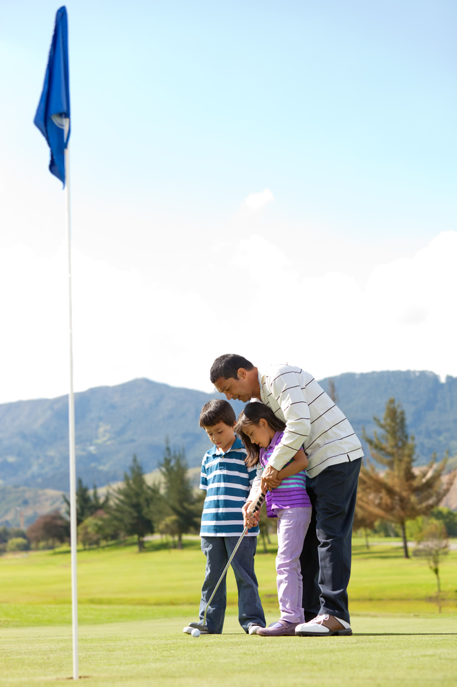 Father teaching his kids how to playing golf Father teaching his kids how to playing golf