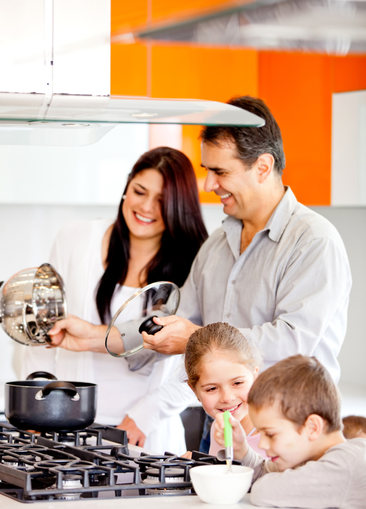 Happy family in the kitchen cooking dinner together Happy family in the kitchen cooking dinner together